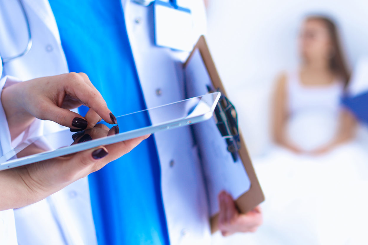 Young woman doctor holding a tablet pc