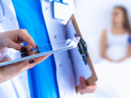 Young woman doctor holding a tablet pc